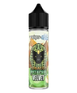 DR VAPES VAPE STATION TOBACCO PISTACHIO VELVET MTL ELIQUID bottle displayed on a luxurious green velvet background surrounded by dried tobacco leaves and cracked green pistachios.