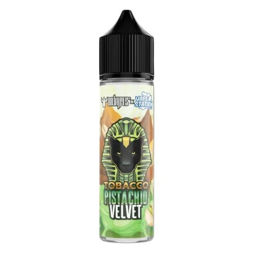 DR VAPES VAPE STATION TOBACCO PISTACHIO VELVET MTL ELIQUID bottle displayed on a luxurious green velvet background surrounded by dried tobacco leaves and cracked green pistachios.